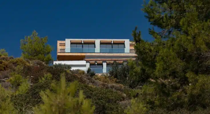 a house on top of a hill surrounded by trees